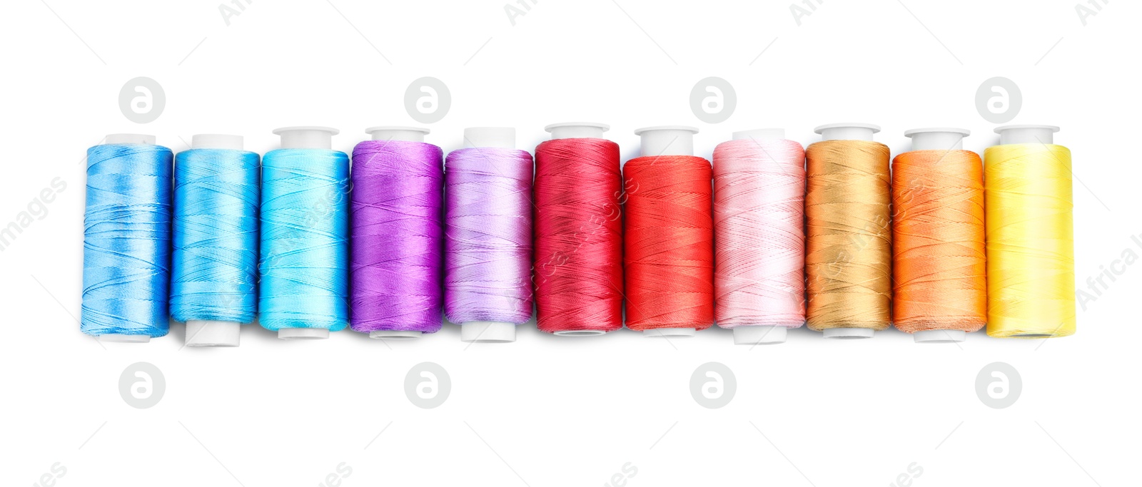 Photo of Spools of bright sewing threads isolated on white, top view