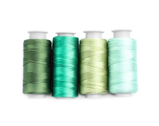 Photo of Spools of bright sewing threads isolated on white, top view