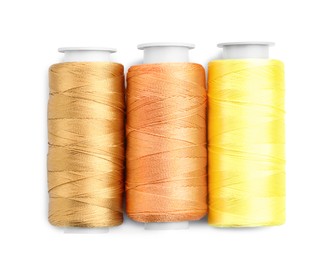 Photo of Spools of bright sewing threads isolated on white, top view