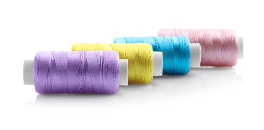 Photo of Spools of bright sewing threads isolated on white