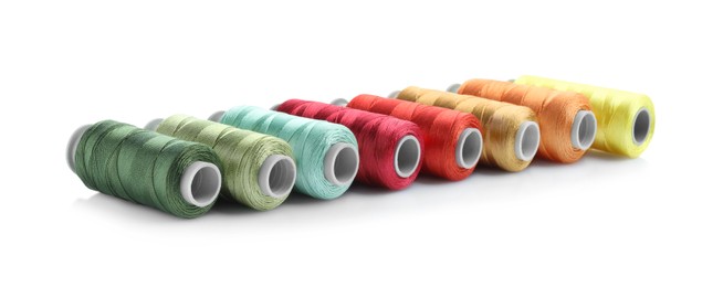 Photo of Spools of bright sewing threads isolated on white