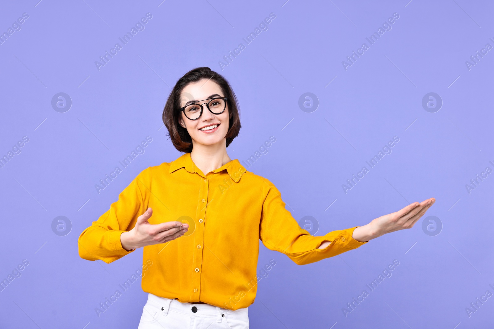 Photo of Happy businesswoman welcoming clients or partners on violet background