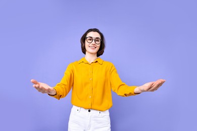 Photo of Happy businesswoman welcoming clients or partners on violet background