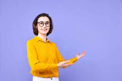 Photo of Happy businesswoman welcoming clients or partners on violet background