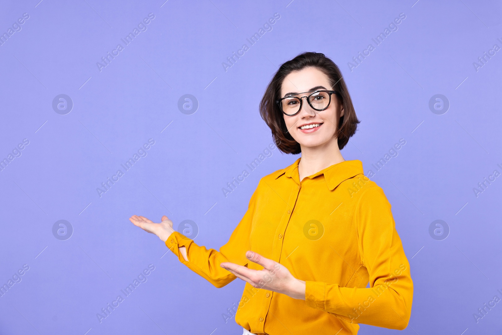 Photo of Happy businesswoman welcoming clients or partners on violet background