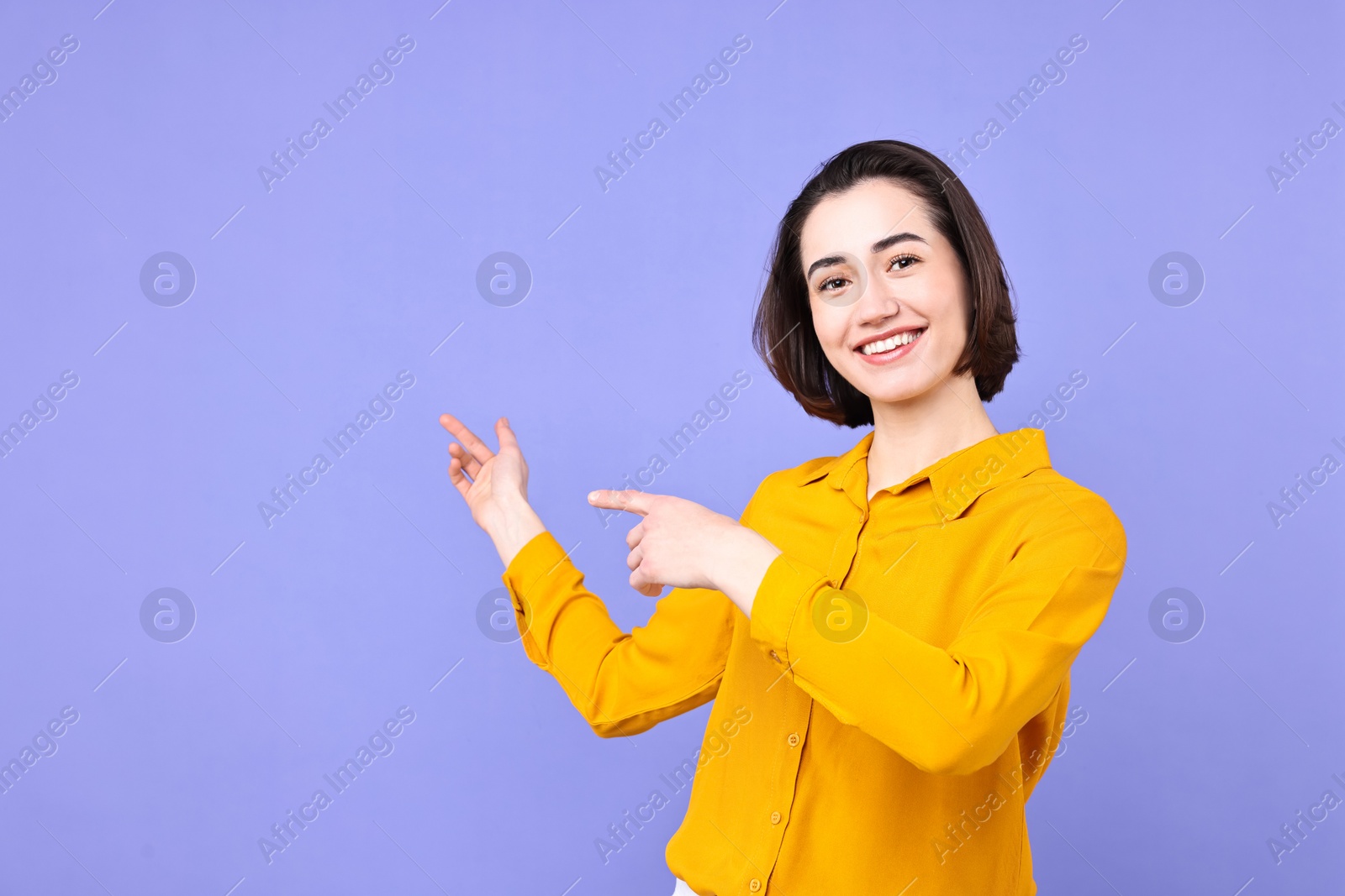 Photo of Happy businesswoman welcoming clients or partners on violet background