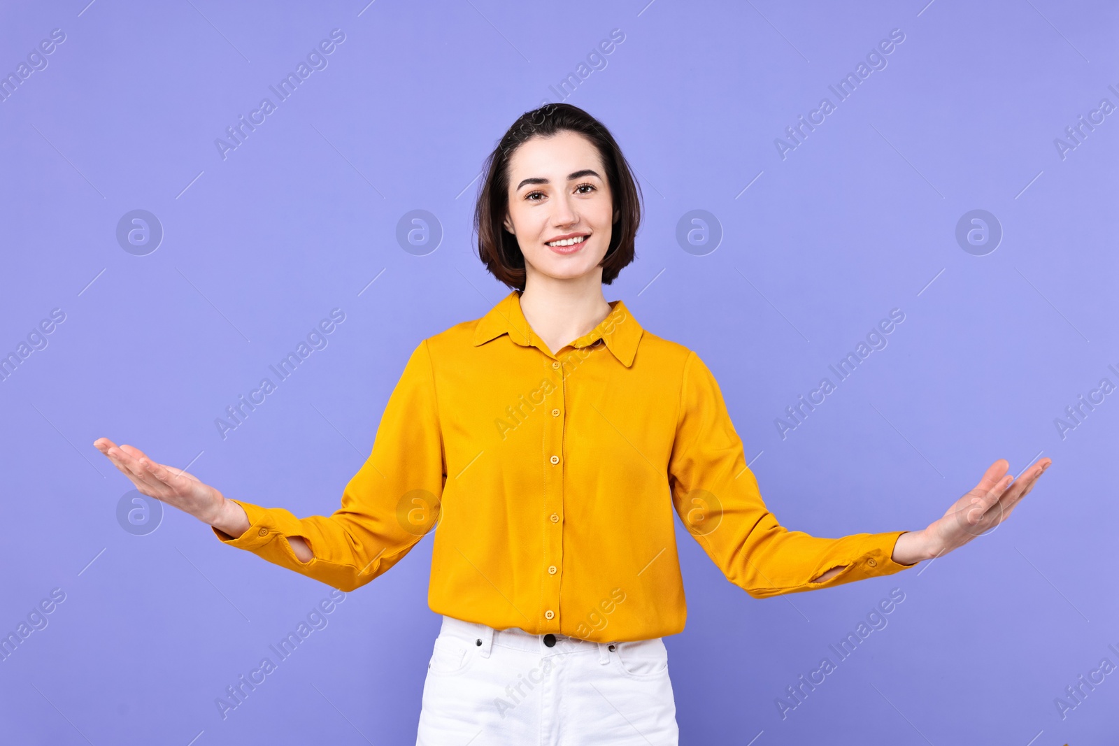 Photo of Happy businesswoman welcoming clients or partners on violet background