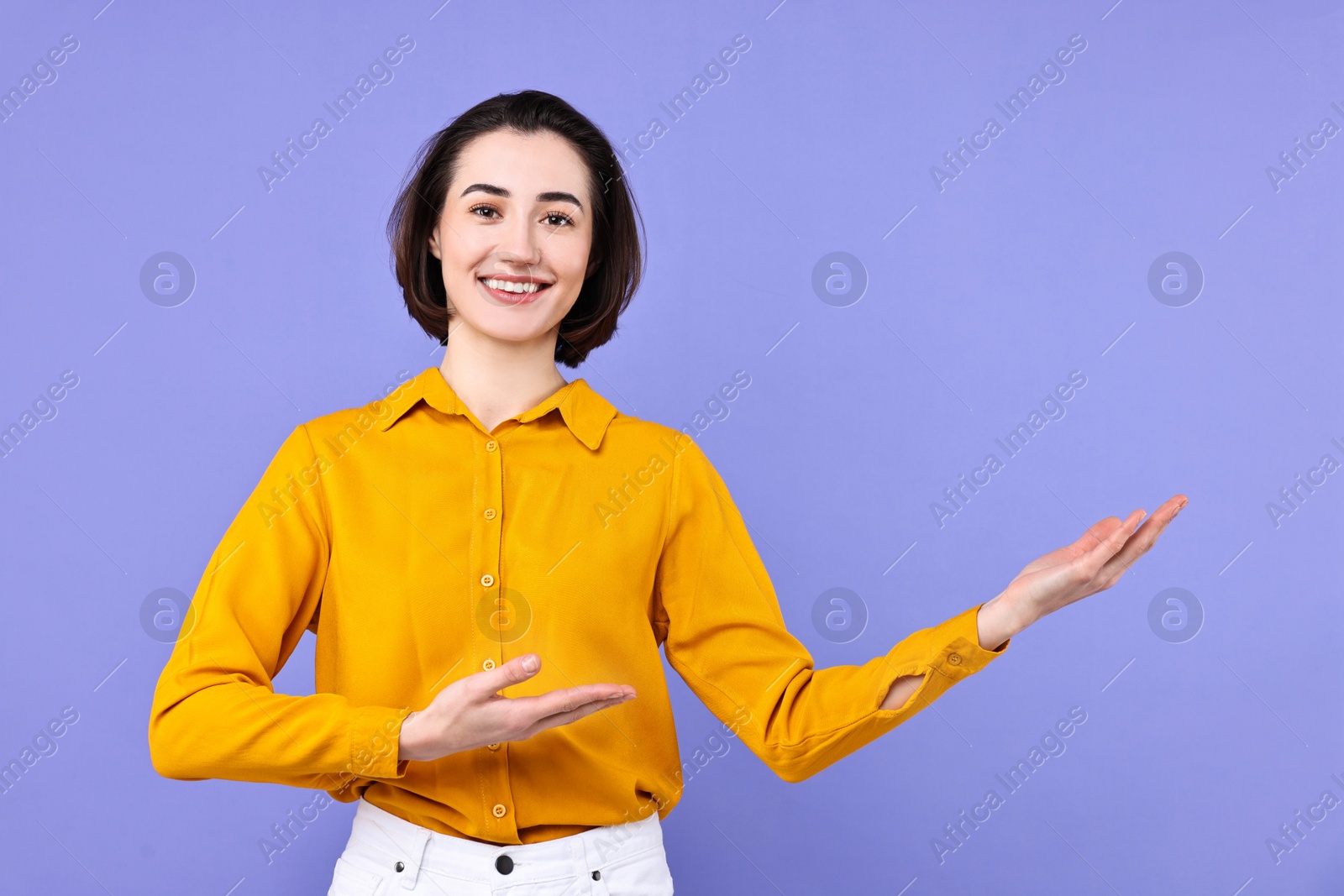 Photo of Happy businesswoman welcoming clients or partners on violet background