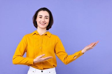 Photo of Happy businesswoman welcoming clients or partners on violet background