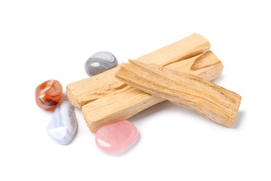 Photo of Palo santo sticks and gemstones isolated on white