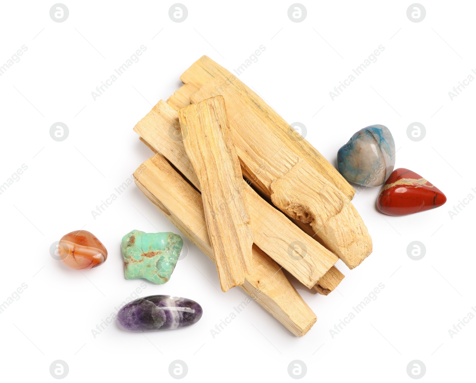 Photo of Palo santo sticks and gemstones isolated on white, top view