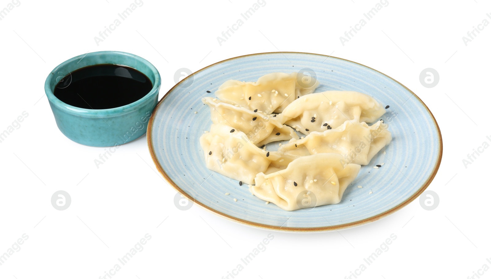 Photo of Tasty gyoza (dumplings) and soy sauce isolated on white