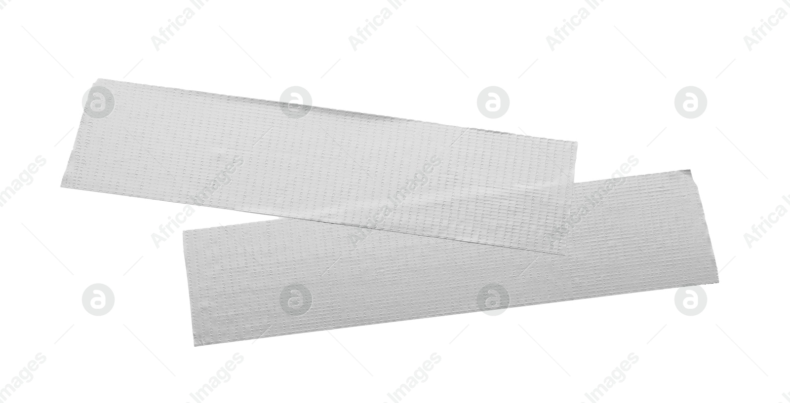 Photo of Strips of silver adhesive tape on white background, top view