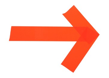 Photo of Arrow made of red adhesive tape on white background, top view