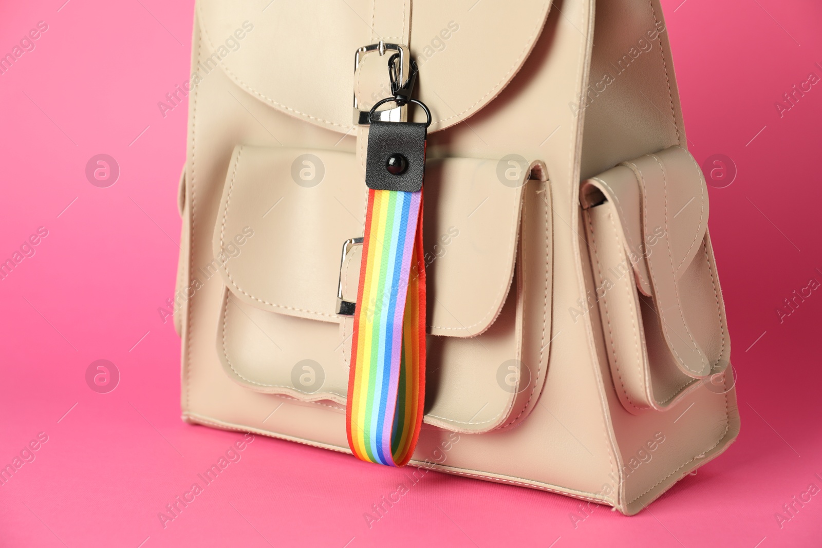 Photo of Backpack with keychain in LGBT colors on pink background