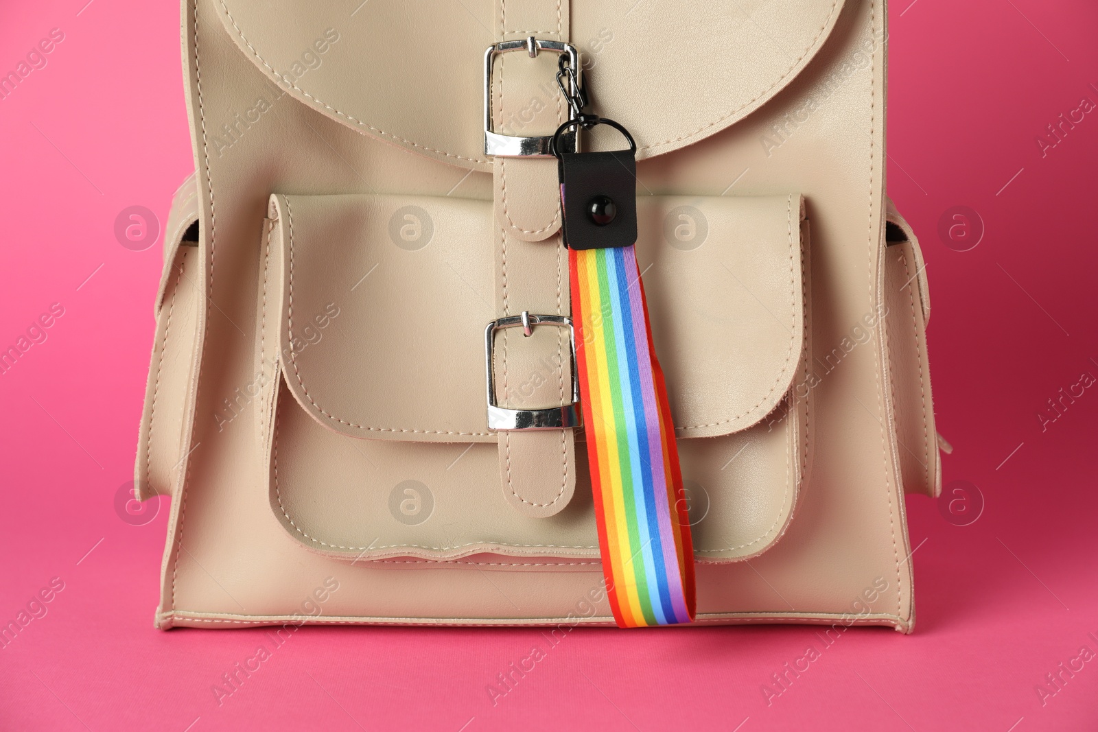 Photo of Backpack with keychain in LGBT colors on pink background