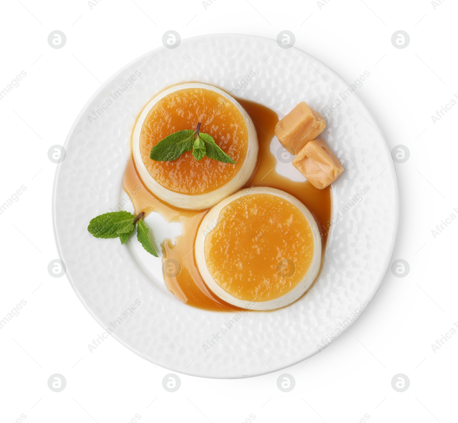 Photo of Tasty puddings with caramel sauce and mint isolated on white, top view