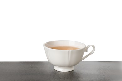 Photo of Refreshing green tea in cup on grey textured table against white background