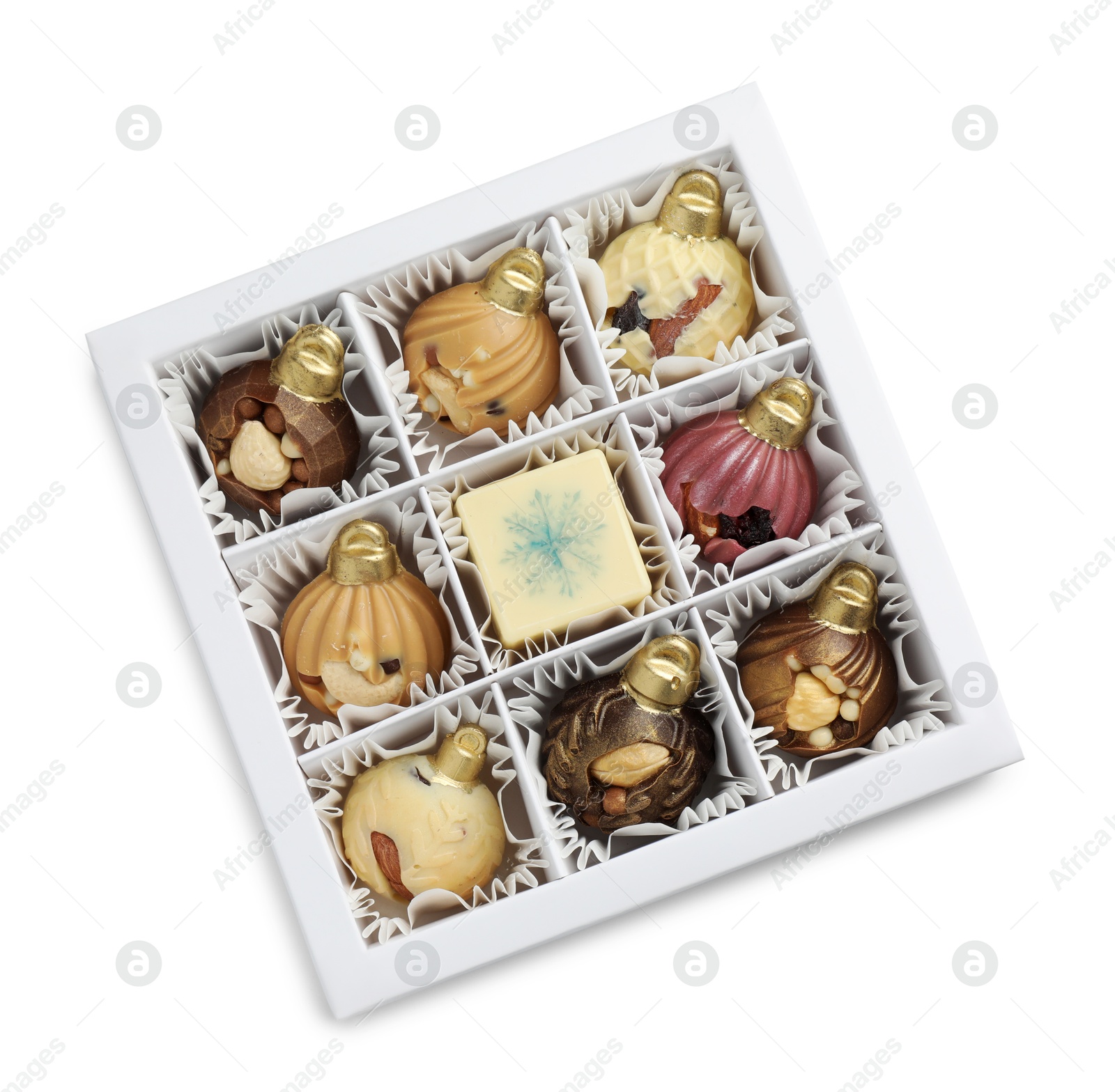 Photo of Box with delicious chocolate in shape of Christmas ornaments isolated on white, top view