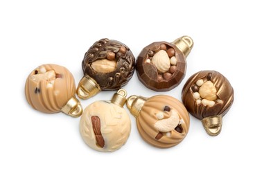 Photo of Delicious chocolate in shape of Christmas baubles isolated on white, top view