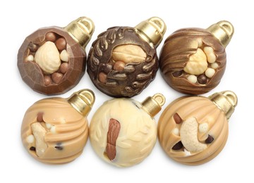 Photo of Delicious chocolate in shape of Christmas baubles isolated on white, top view