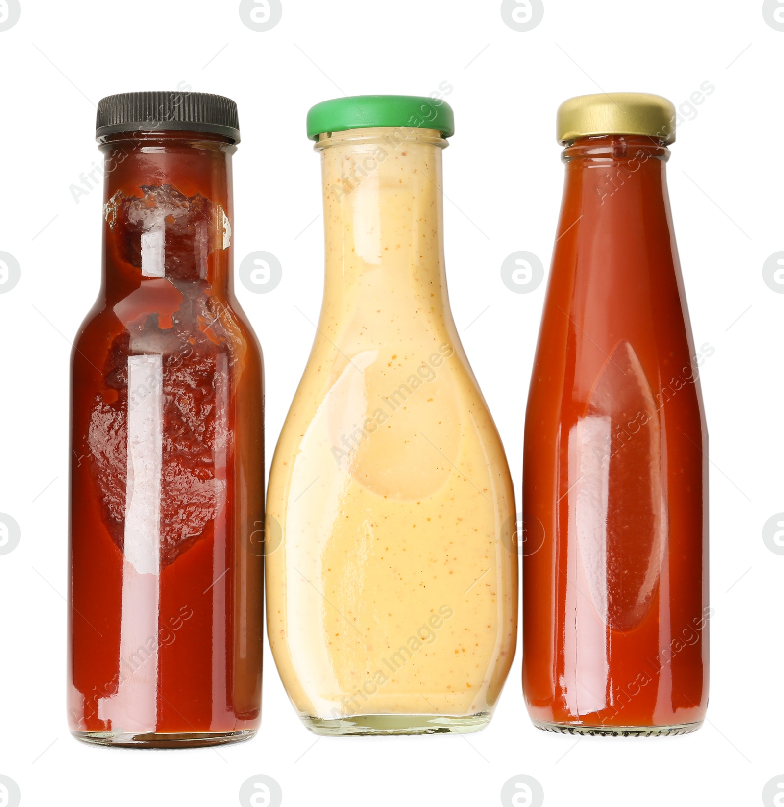 Photo of Different delicious sauces in glass bottles isolated on white, top view