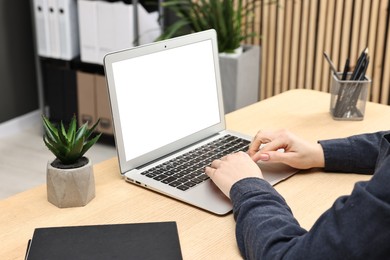 Photo of Woman working on computer at desk indoors, closeup