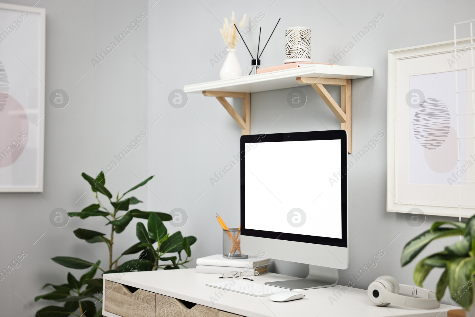 Photo of Comfortable workplace with modern computer on white table indoors