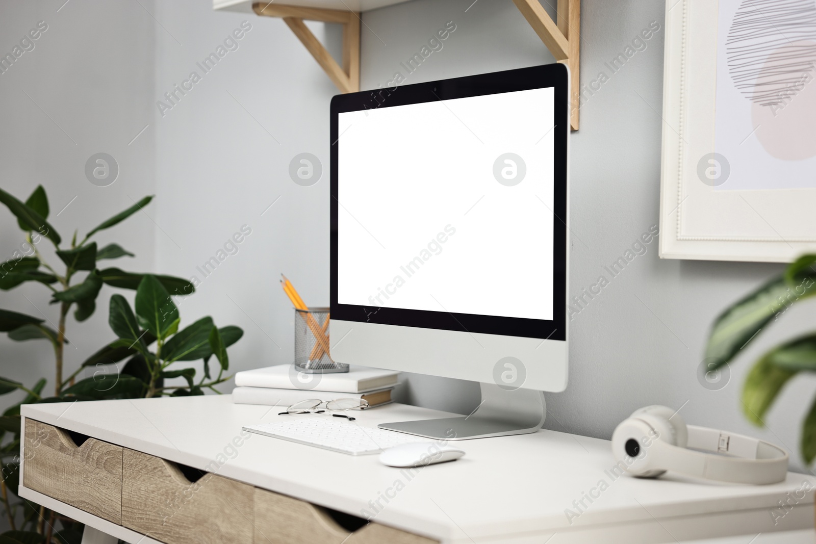 Photo of Comfortable workplace with modern computer on white table indoors