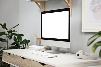 Photo of Comfortable workplace with modern computer on white table indoors