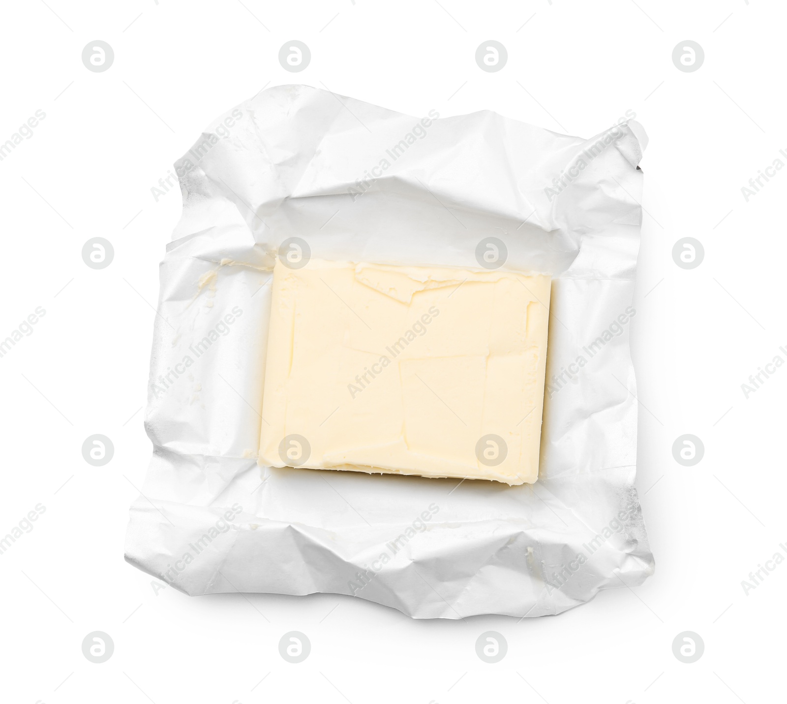 Photo of Block of tasty butter in open package isolated on white, top view