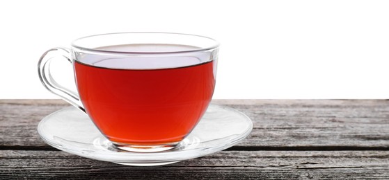 Photo of Refreshing black tea in cup on wooden table against white background