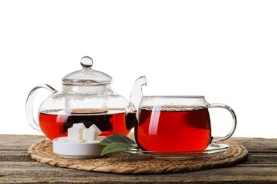 Photo of Refreshing black tea and sugar on wooden table against white background