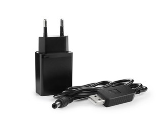 Photo of Black USB power adapter and charge cable isolated on white