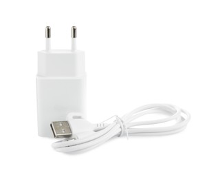 Photo of USB power adapter and charge cable isolated on white