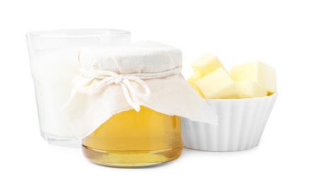 Photo of Jar of honey, milk in glass and butter isolated on white