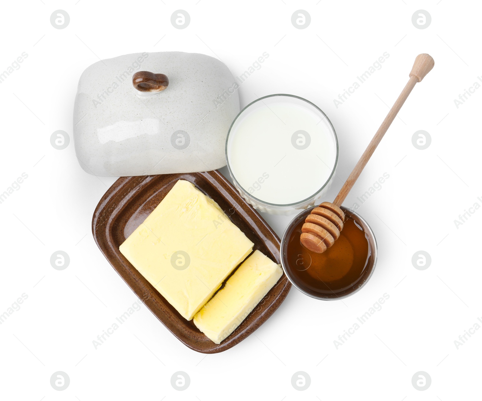 Photo of Fresh milk in glass, honey and butter isolated on white, top view