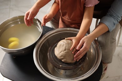 Photo of Hobby and craft. Mother with her daughter making pottery indoors, closeup