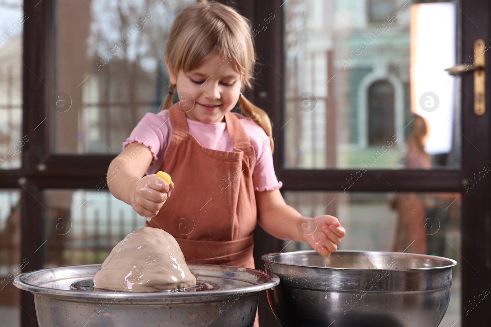 Photo of Hobby and craft. Little girl making pottery indoors