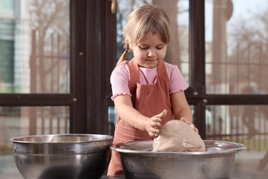 Photo of Hobby and craft. Little girl making pottery indoors