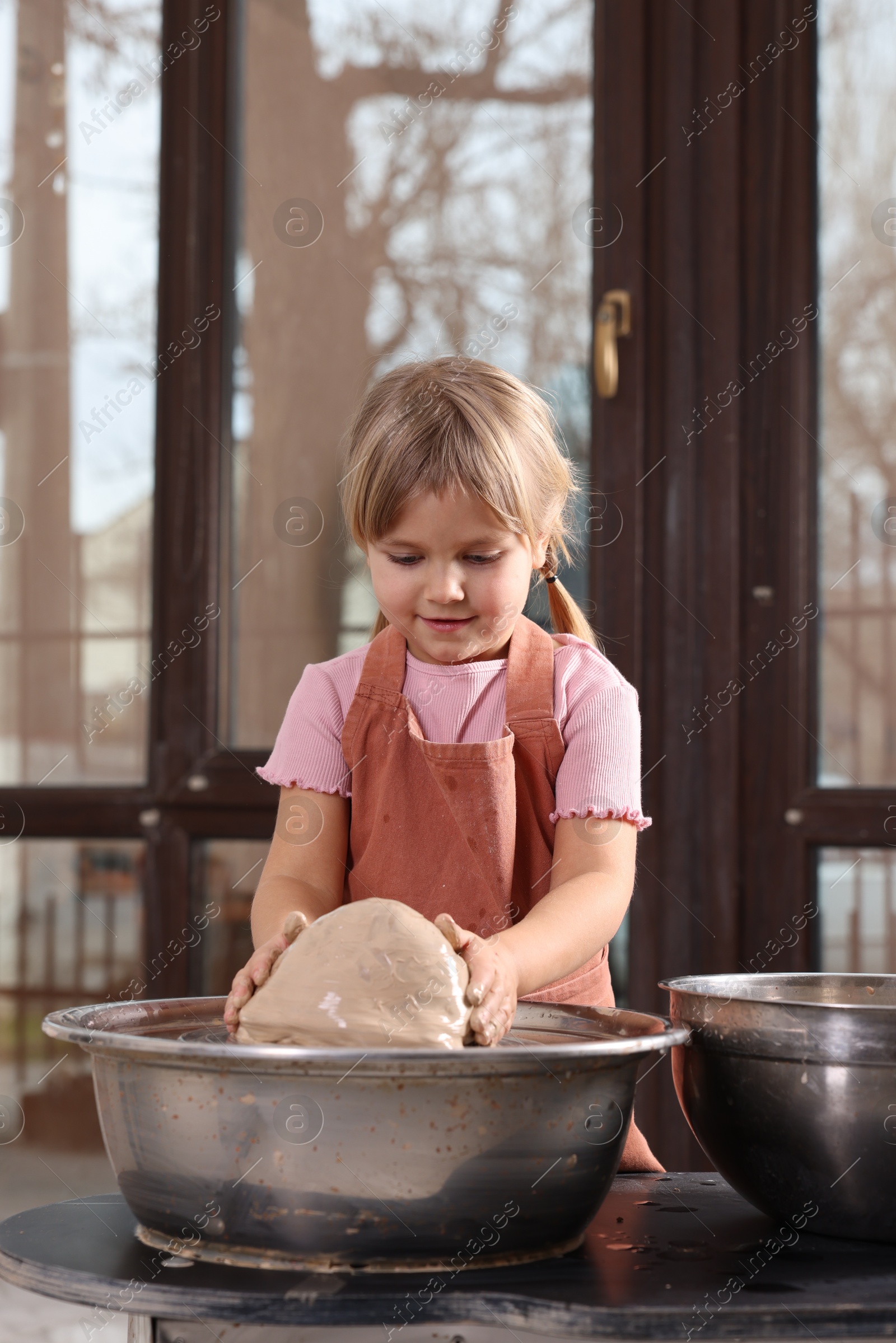 Photo of Hobby and craft. Little girl making pottery indoors