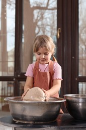 Photo of Hobby and craft. Little girl making pottery indoors