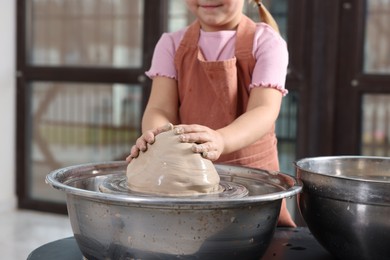 Photo of Hobby and craft. Girl making pottery indoors, closeup