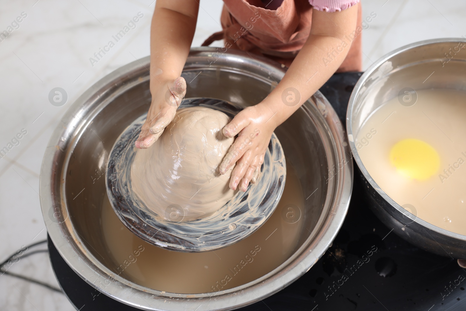 Photo of Hobby and craft. Girl making pottery indoors, closeup