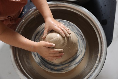 Photo of Hobby and craft. Girl making pottery indoors, above view