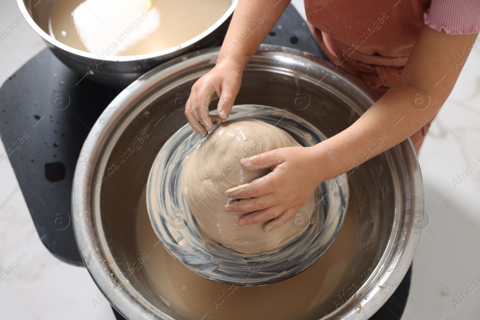 Photo of Hobby and craft. Girl making pottery indoors, closeup