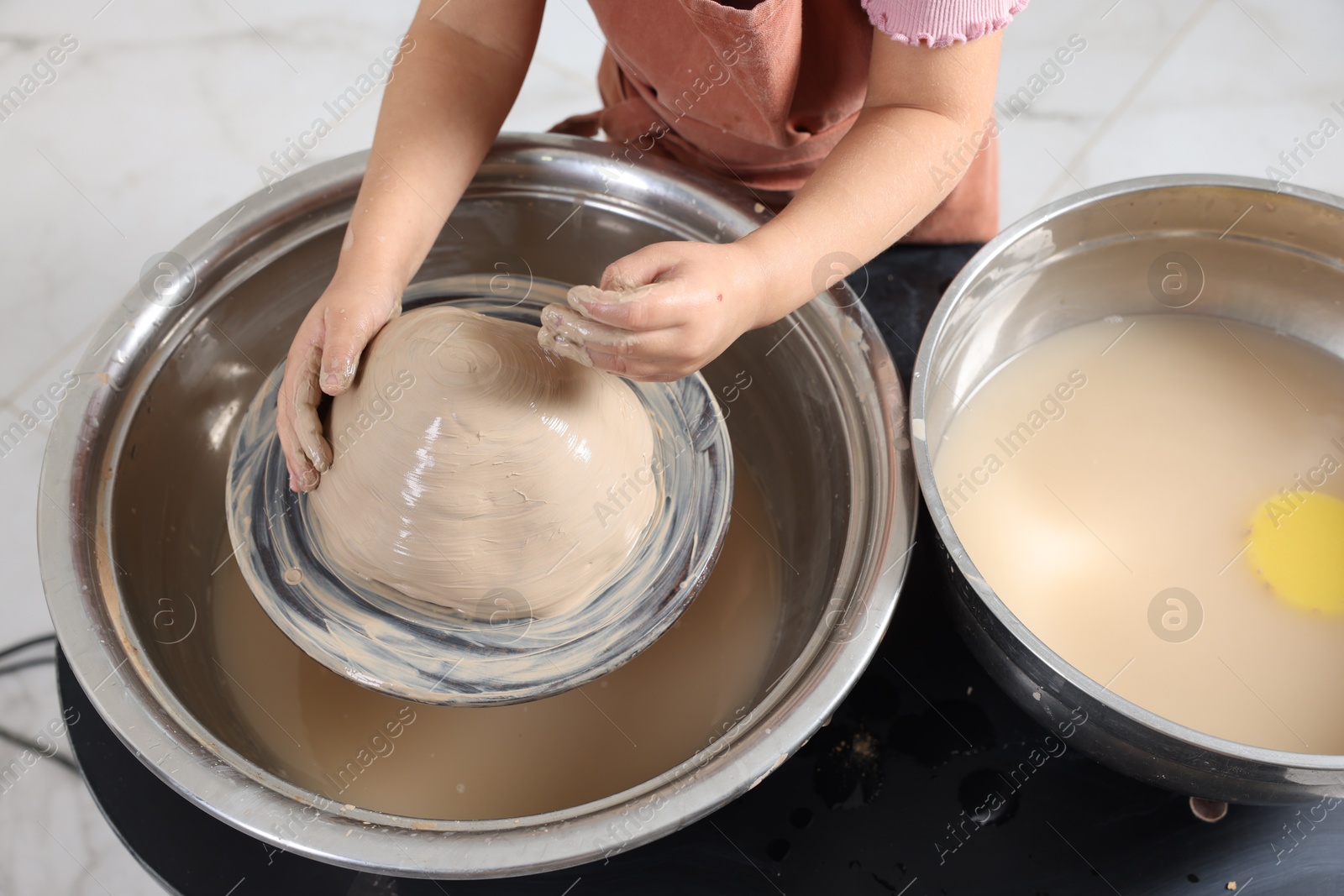 Photo of Hobby and craft. Girl making pottery indoors, closeup