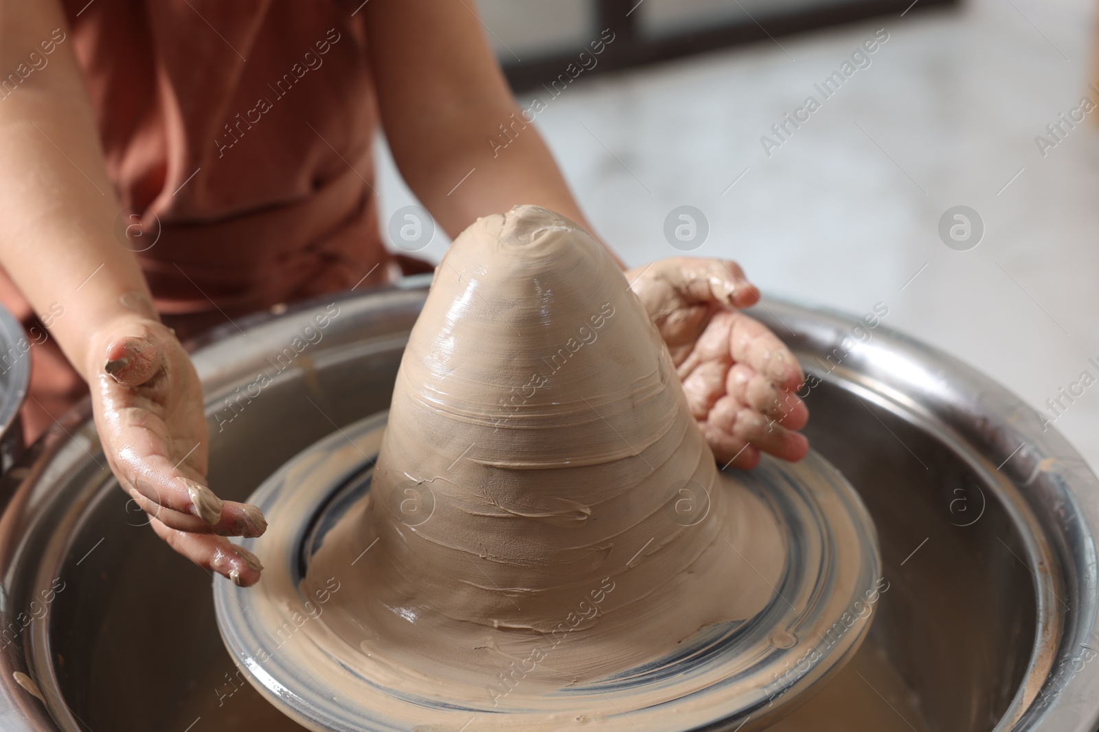 Photo of Hobby and craft. Girl making pottery indoors, closeup