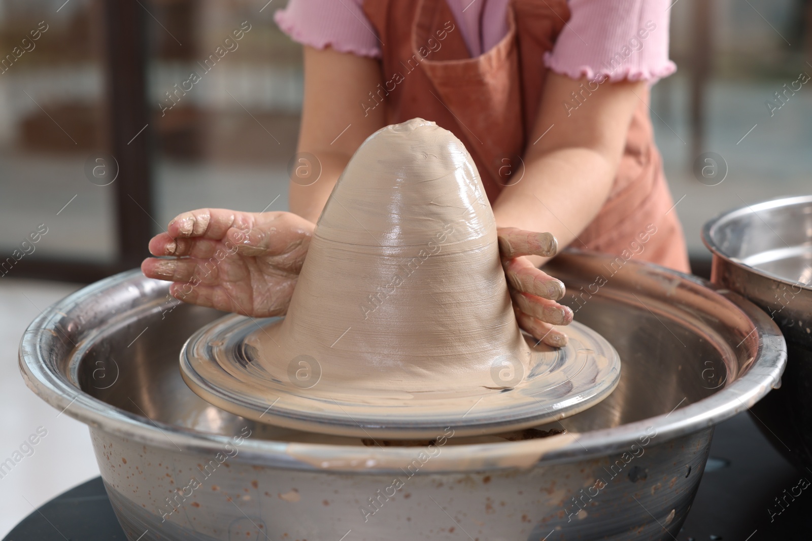 Photo of Hobby and craft. Girl making pottery indoors, closeup