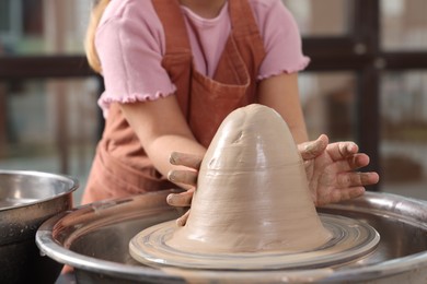 Photo of Hobby and craft. Girl making pottery indoors, closeup